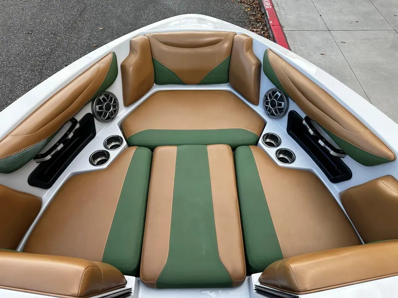 Slide: The Image of 2021 Axis T22 boat interior with tan and green cushioned seating. - 28