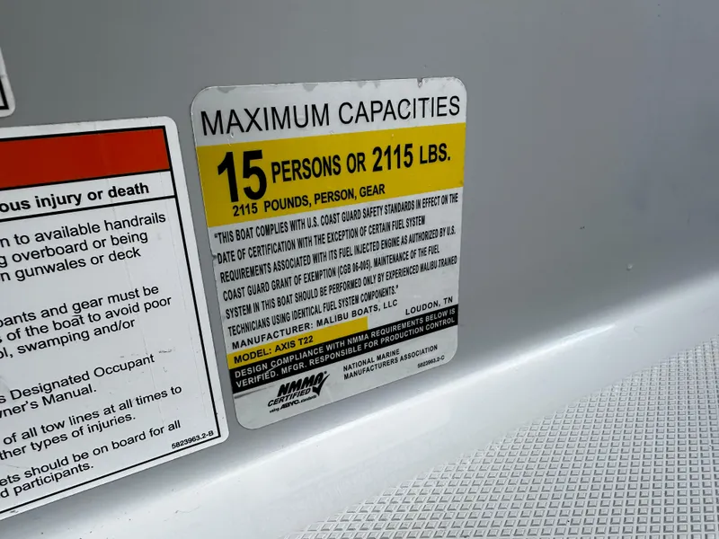 Slide: The Image of 2021 Axis T22 boat capacity label, 15 persons or 2115 lbs limit. - 29