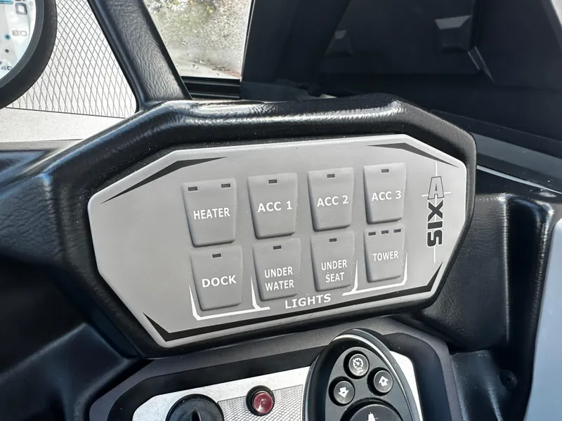 Slide: The Image of Control panel of a 2021 Axis T22 boat with various switches. - 32