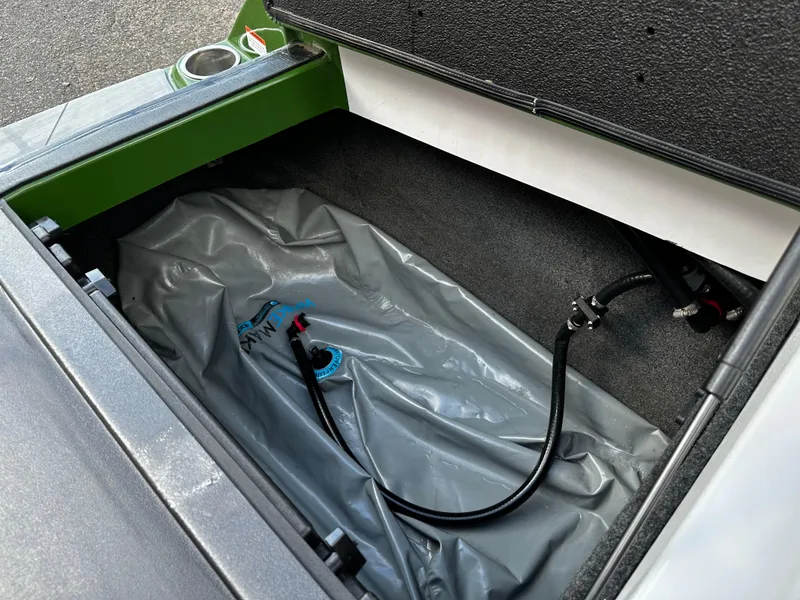 Slide: The Image of 2021 Axis T22 boat storage compartment with ballast bag and hose. - 38
