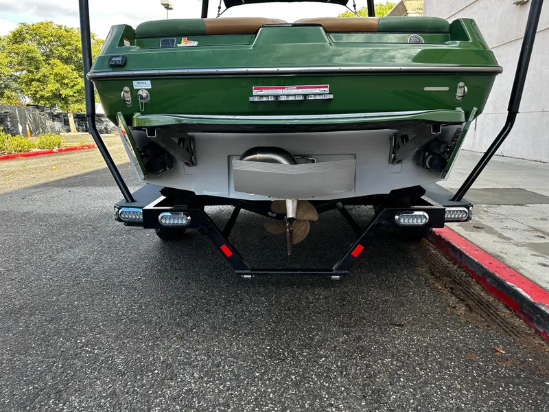 Slide: The Image of 2021 Axis T22 boat rear view with green exterior and propeller. - 6