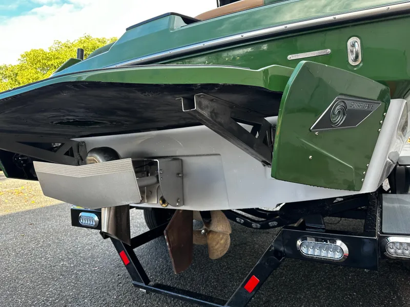 Slide: The Image of 2021 Axis T22 boat rear view showing propeller and trim tabs. - 8