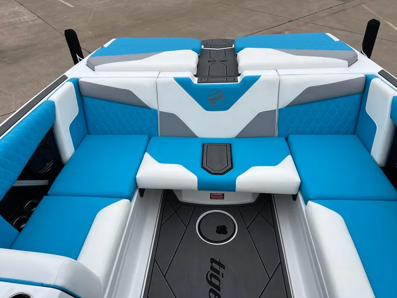 Slide: The Image of 2024 Tigé Z3 boat interior with blue and white seating, modern design. - 10