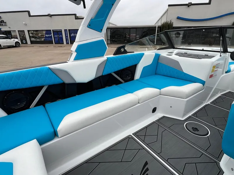 Slide: The Image of 2024 Tigé Z3 boat interior with blue and white seating, modern design, and spacious layout. - 14