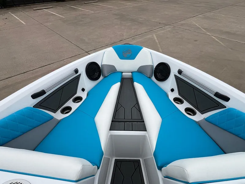Slide: The Image of 2024 Tigé Z3 boat interior with blue and white seating, cup holders, and speakers. - 18