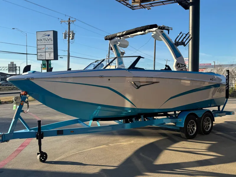 Slide: The Image of 2024 Tigé Z3 boat on trailer at dealership, showcasing sleek design and vibrant colors. - 5