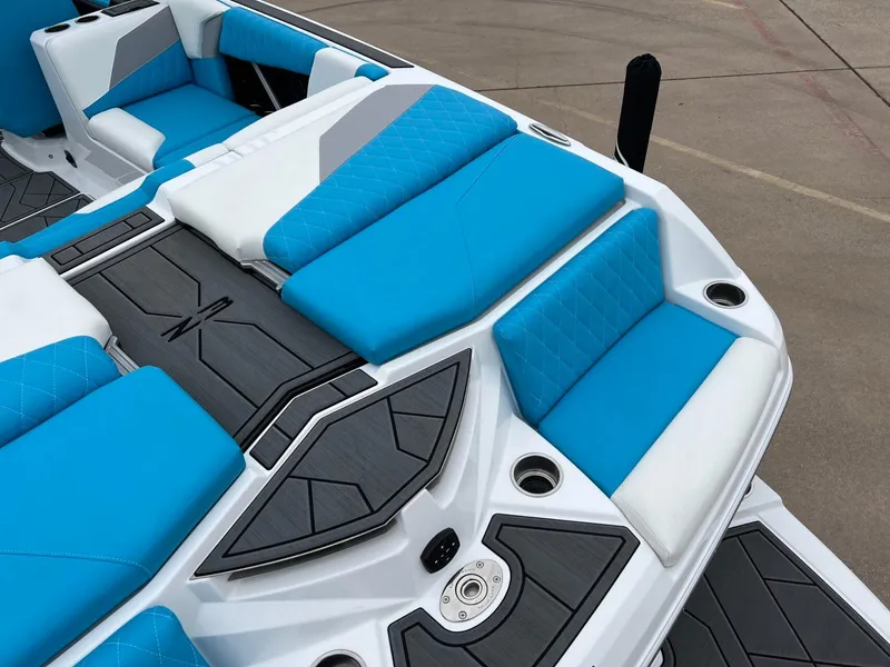 Slide: The Image of 2024 Tigé Z3 boat interior with blue and white seating, modern design. - 8