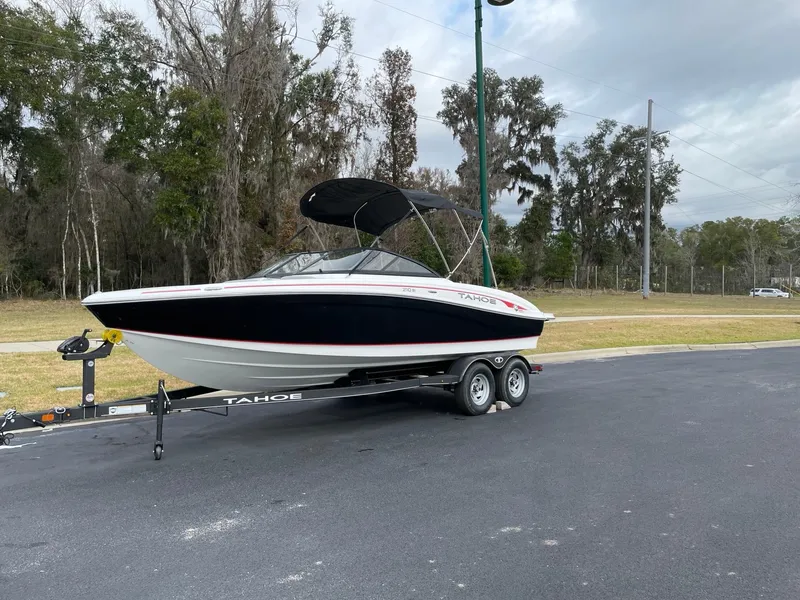 The Image of 2024 Tahoe 210 Si boat on a trailer, parked outdoors. - 0