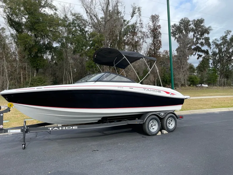 Slide: The Image of 2024 Tahoe 210 Si boat on trailer with black and white exterior. - 2