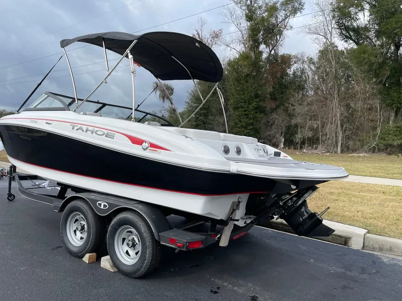 Slide: The Image of 2024 Tahoe 210 Si boat on a trailer with a black canopy. - 3
