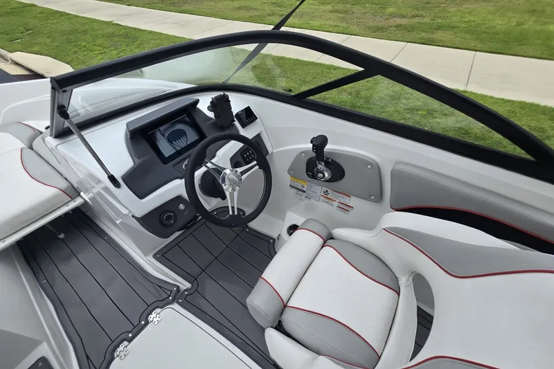 Slide: The Image of 2024 Tahoe 210 Si boat interior with modern dashboard and steering wheel design. - 6