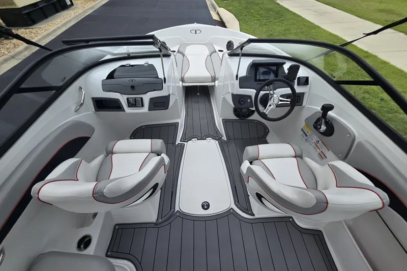 Slide: The Image of 2024 Tahoe 210 Si boat interior with modern seating and sleek dashboard design. - 5