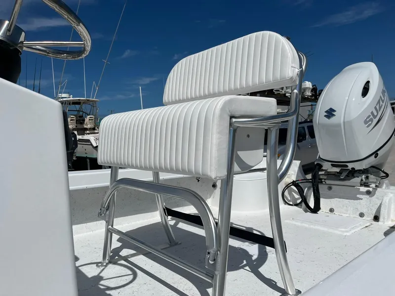 Slide: The Image of 2025 C-Hawk 23 Center Console boat with white seating and Suzuki outboard motor. - 7