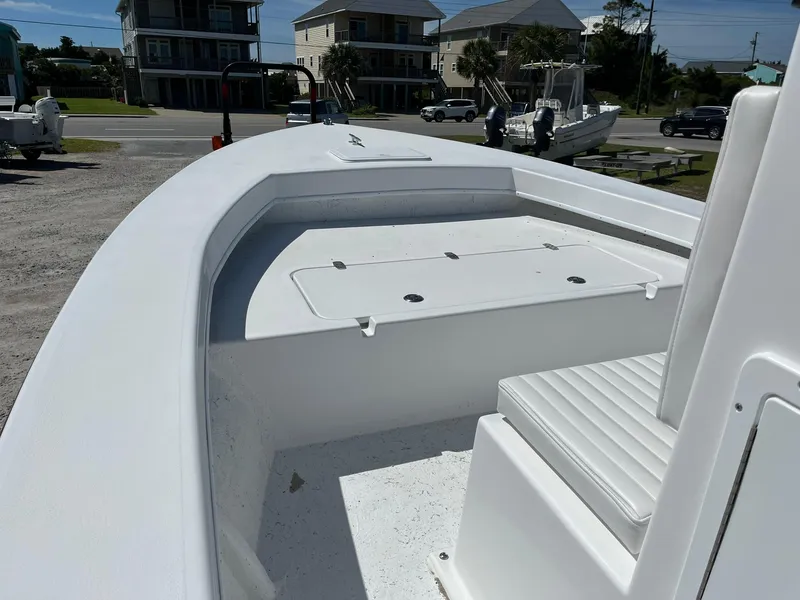 Slide: The Image of 2025 C-Hawk 23 Center Console boat, white deck, docked near coastal homes. - 9