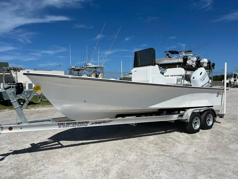 Slide: The Image of 2026 C-Hawk 23 Center Console boat with seating, docked under clear skies. - 6