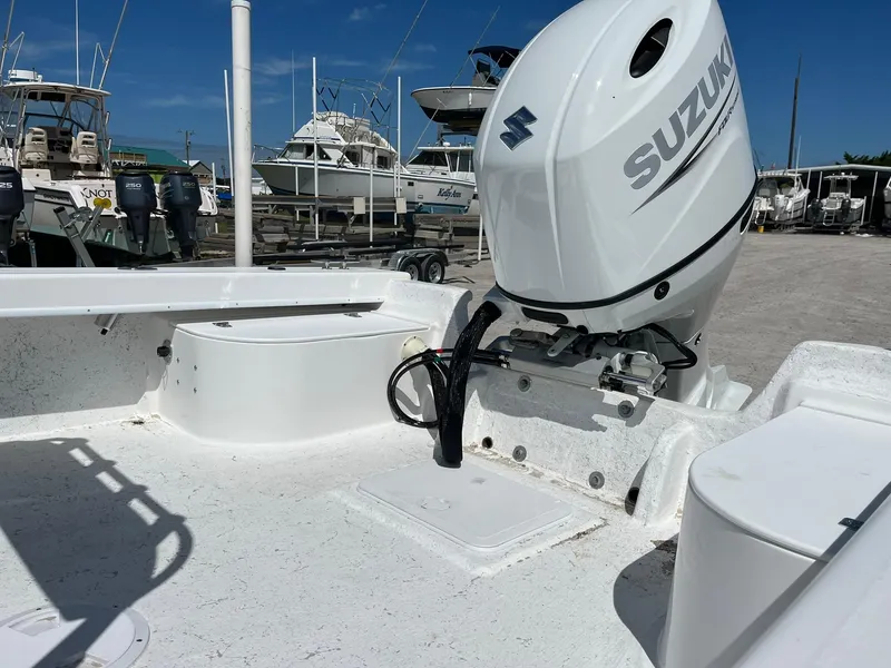 Slide: The Image of 2026 C-Hawk 23 Center Console boat with Suzuki outboard motor in a marina setting. - 8
