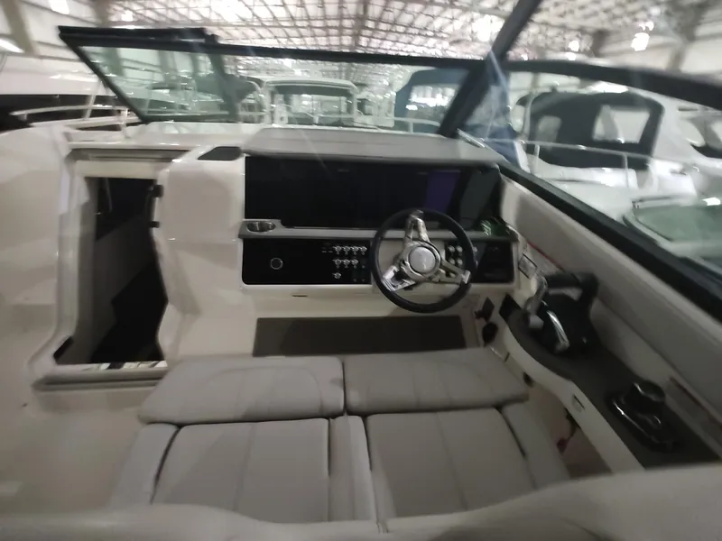 Slide: The Image of 2023 Sea Ray 320 Sundancer cockpit with modern helm and seating. - 13