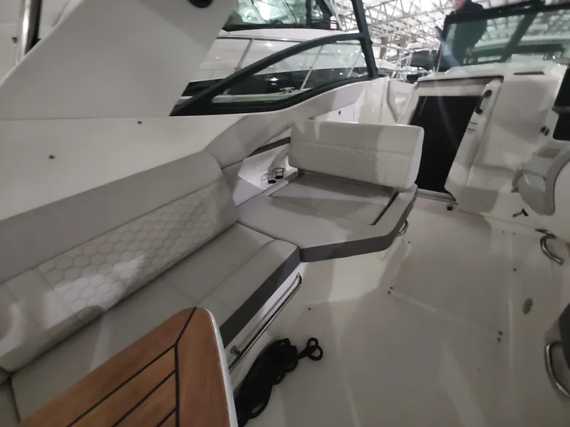 Slide: The Image of 2023 Sea Ray 320 Sundancer interior seating area with modern design and comfortable upholstery. - 15