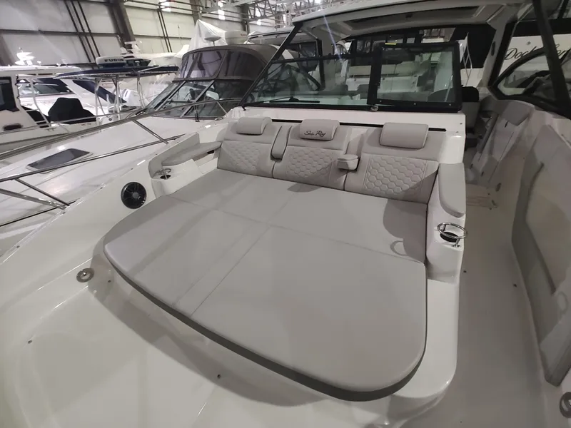 Slide: The Image of 2023 Sea Ray 320 Sundancer boat interior with spacious seating. - 24