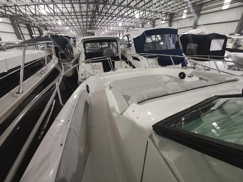 Slide: The Image of 2023 Sea Ray 320 Sundancer in a boat showroom. - 27