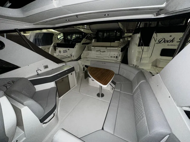 Slide: The Image of Interior of 2023 Sea Ray 320 Sundancer yacht with seating and table. - 33