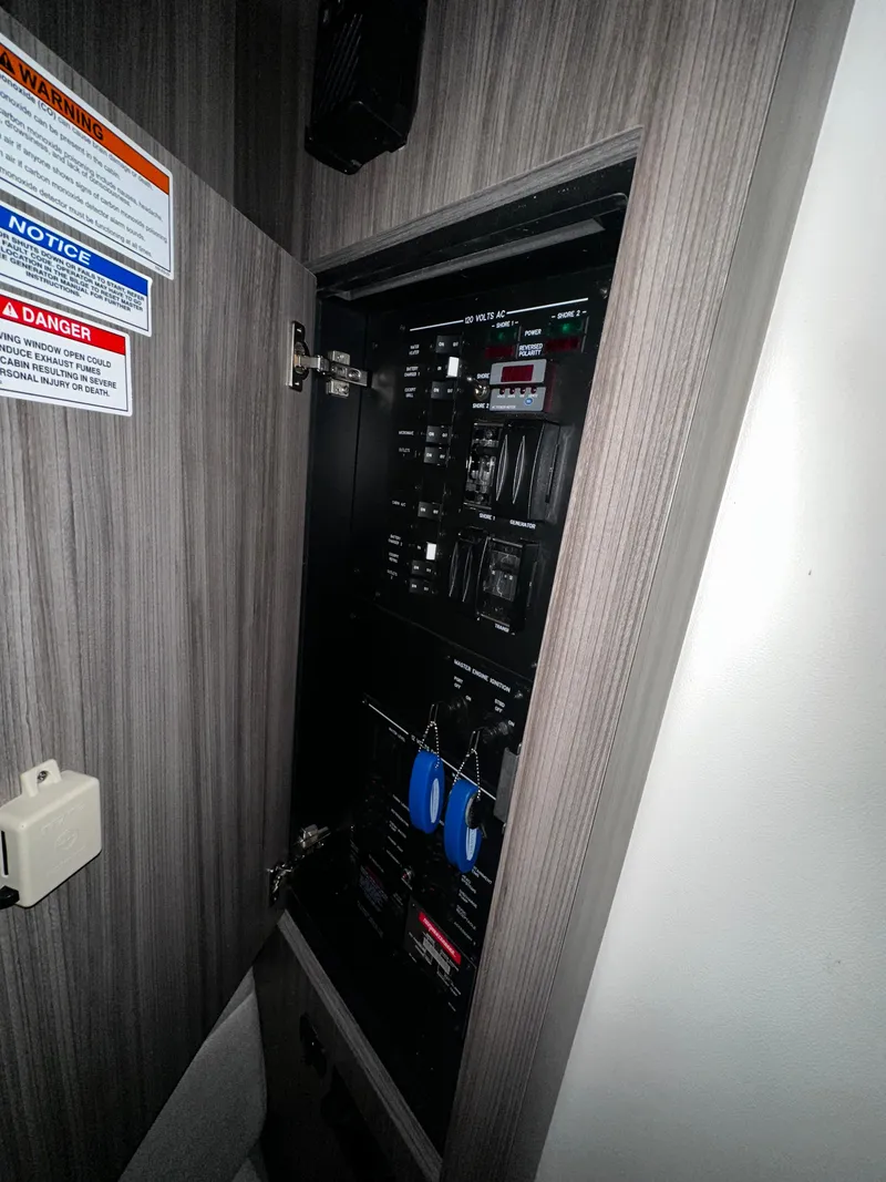 Slide: The Image of Electrical panel inside 2023 Sea Ray 320 Sundancer boat. - 37