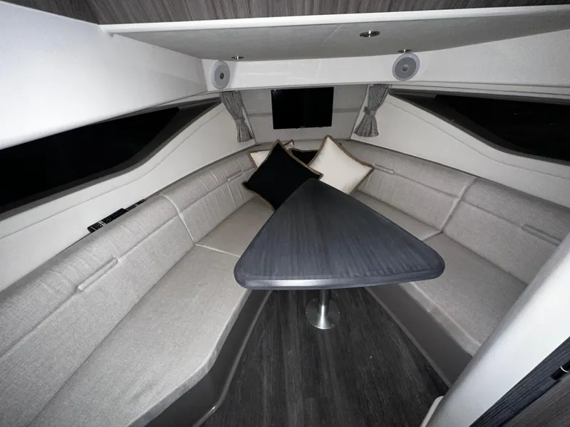 Slide: The Image of Interior of 2023 Sea Ray 320 Sundancer with modern seating and table. - 39