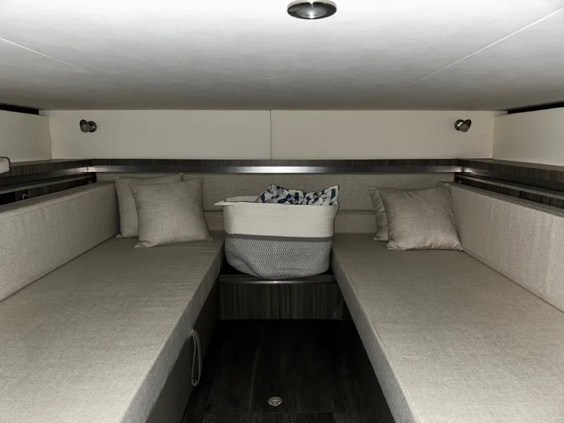 Slide: The Image of Interior cabin of 2023 Sea Ray 320 Sundancer with twin beds and pillows. - 43