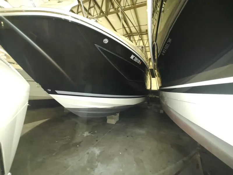 Slide: The Image of 2023 Sea Ray 320 Sundancer boats in indoor storage facility. - 9