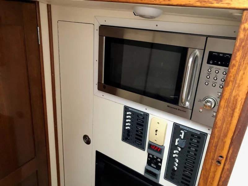 Slide: The Image of Built-in microwave and control panel in 2005 Morgan 31 boat interior. - 15