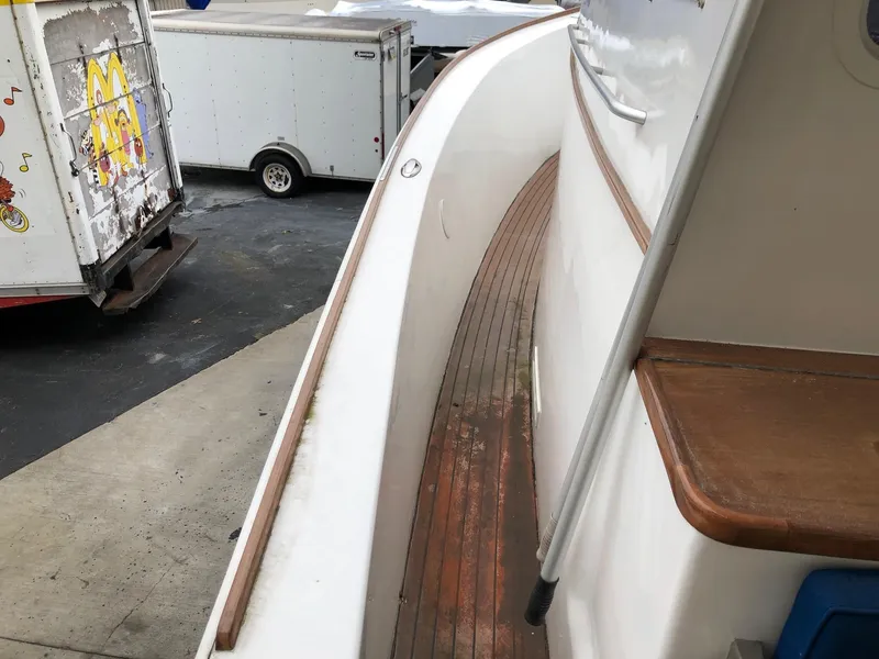 Slide: The Image of Side deck of a 2005 Morgan 31 boat with wooden trim. - 6