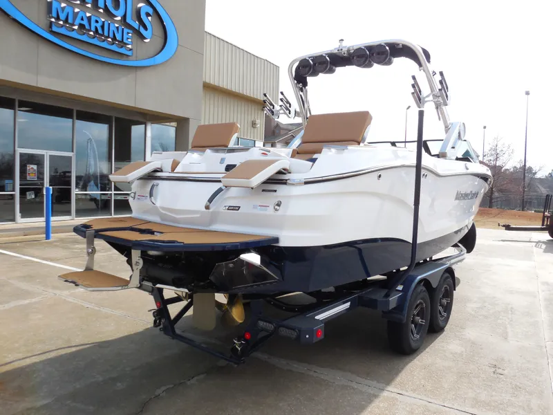 Slide: The Image of 2024 MasterCraft X24 boat on trailer outside dealership. - 3