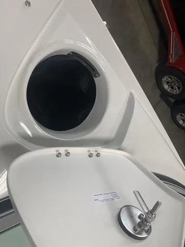 Slide: The Image of 2024 Crownline E255 boat storage compartment with open hatch. - 14