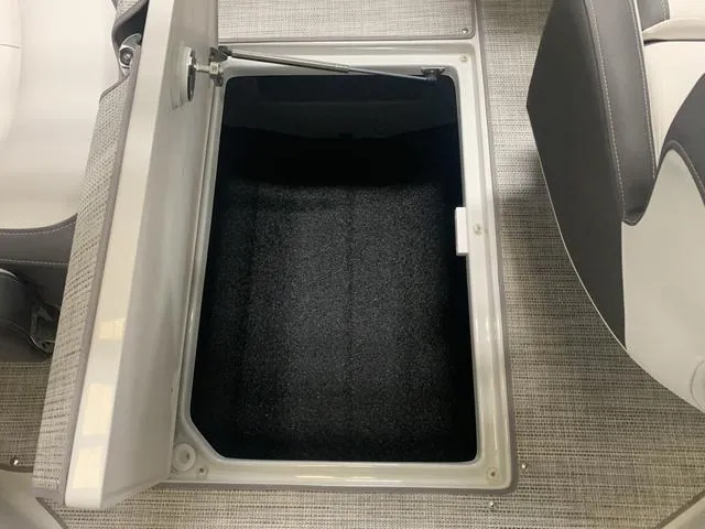 Slide: The Image of 2024 Crownline E255 boat storage compartment with open hatch. - 16