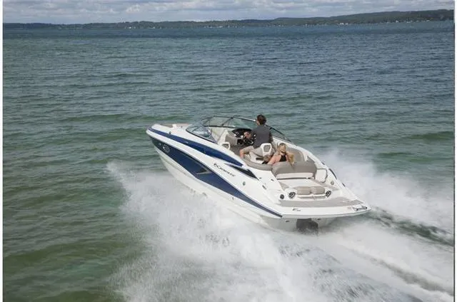 Slide: The Image of 2024 Crownline E255 boat cruising on open water. - 22