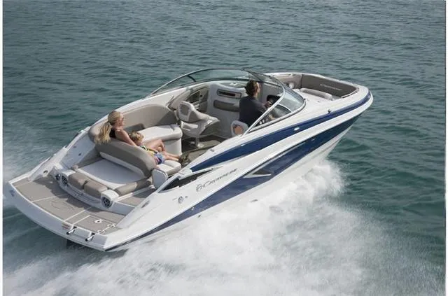 Slide: The Image of 2024 Crownline E255 boat cruising on open water. - 24