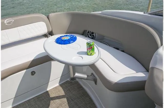 Slide: The Image of 2024 Crownline E255 boat interior with seating and table. - 26