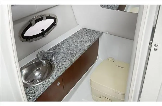 Slide: The Image of 2024 Crownline E255 boat bathroom with granite countertop and stainless steel sink. - 28