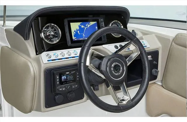 Slide: The Image of 2024 Crownline E255 boat dashboard with navigation system and controls. - 29