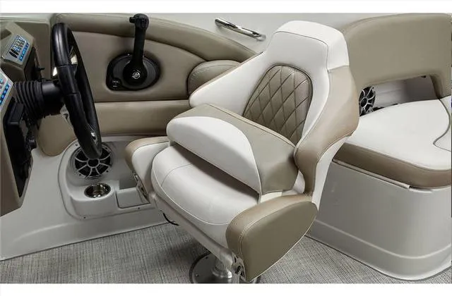 Slide: The Image of 2024 Crownline E255 boat interior with luxurious captain's chair and modern dashboard. - 31