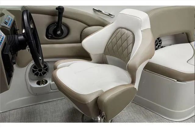 Slide: The Image of 2024 Crownline E255 boat captain's chair and helm station. - 32