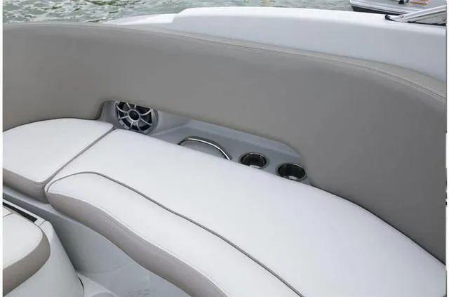 Slide: The Image of 2024 Crownline E255 boat interior with cushioned seating and built-in cup holders. - 34