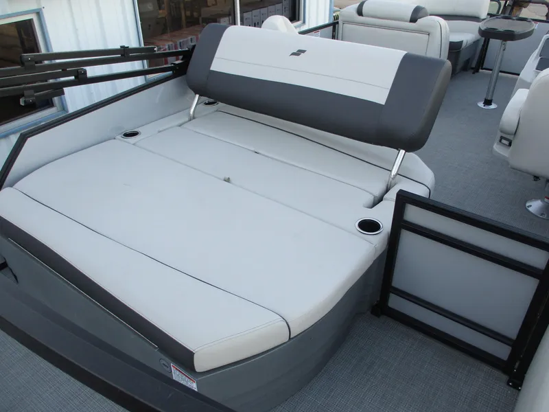 Slide: The Image of 2024 Starcraft EXS 1 Q DH boat interior seating area with cup holders. - 10