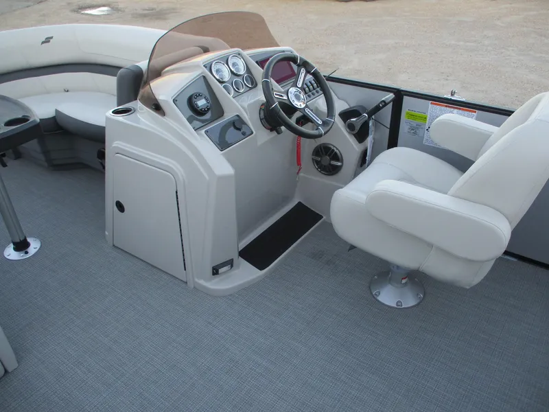 Slide: The Image of 2024 Starcraft EXS 1 Q DH boat interior with captain's chair and control console. - 15
