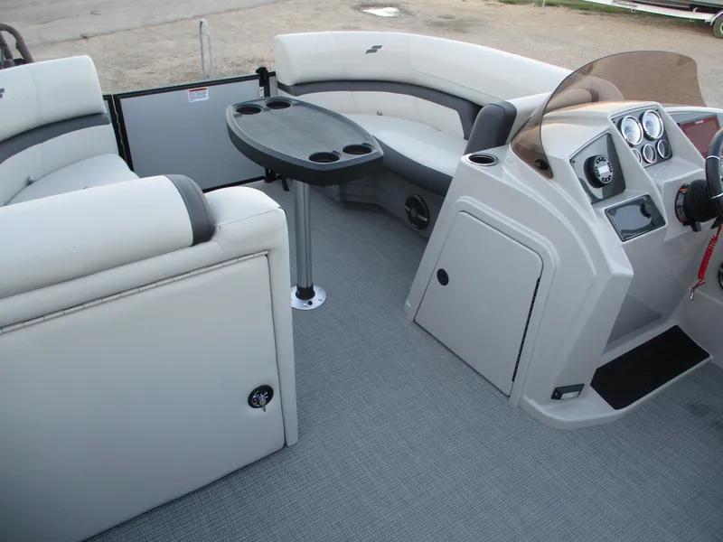 Slide: The Image of 2024 Starcraft EXS 1 Q DH pontoon boat interior with seating and control console. - 16