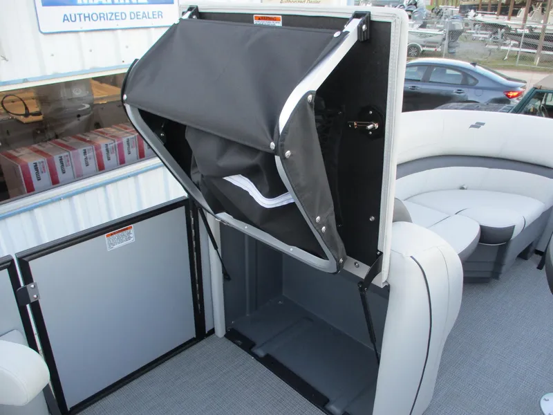 Slide: The Image of 2024 Starcraft EXS 1 Q DH boat interior with storage compartment open. - 17