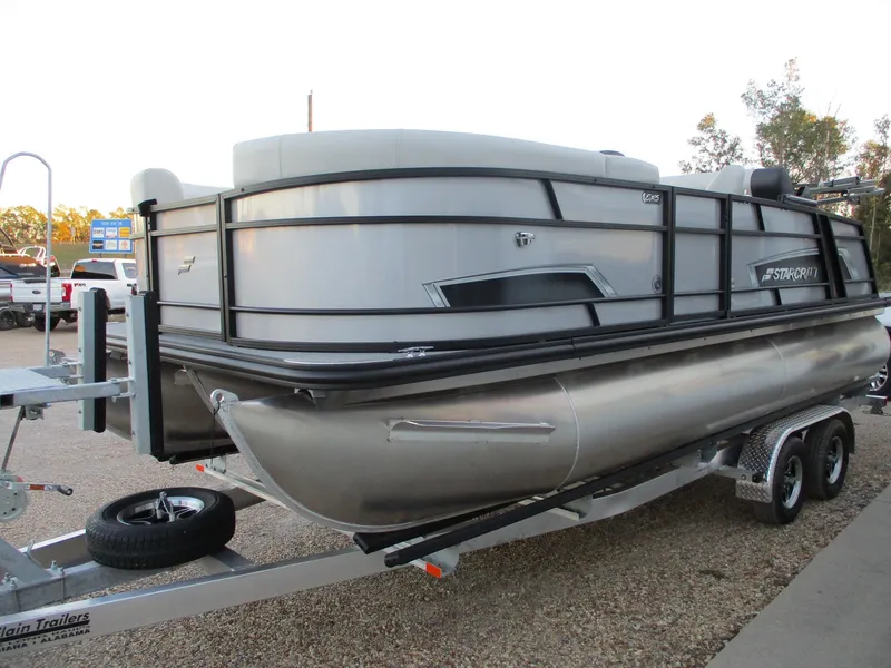 Slide: The Image of 2024 Starcraft EXS 1 Q DH pontoon boat on a trailer. - 2