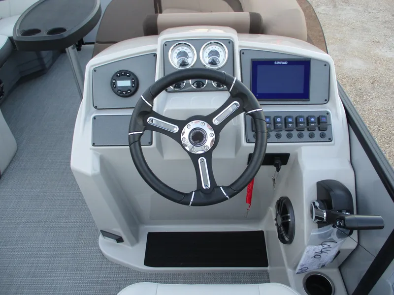 Slide: The Image of 2024 Starcraft EXS 1 Q DH boat dashboard with steering wheel and control panel. - 7