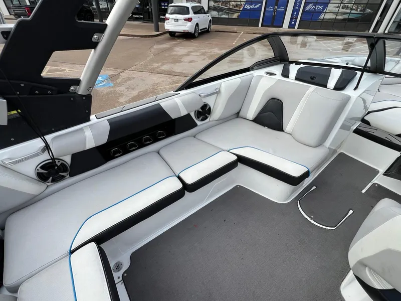 Slide: The Image of 2018 Malibu 21 VLX boat interior with white seating and modern design. - 10