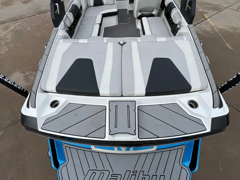 Slide: The Image of 2018 Malibu 21 VLX boat interior with gray and black seating, viewed from above. - 4
